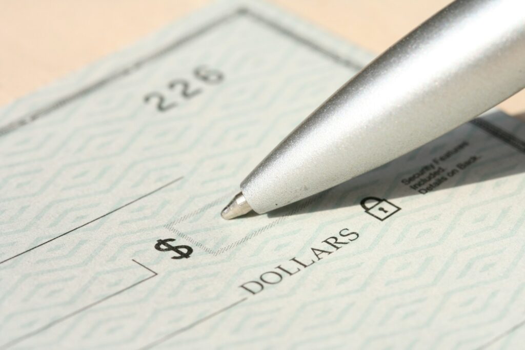 Pen poised over a check, ready to write.